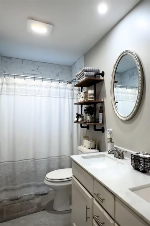 bathroom featuring toilet, vanity, and a shower with shower curtain