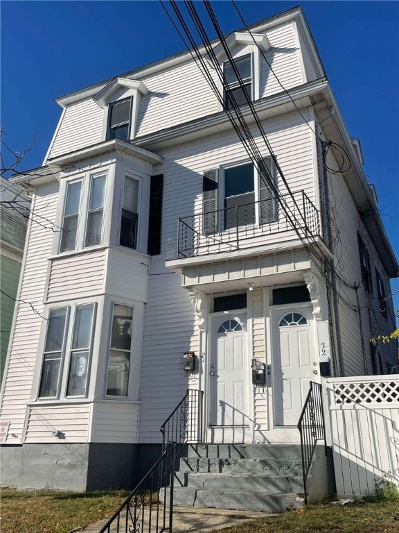 view of front of house featuring a balcony