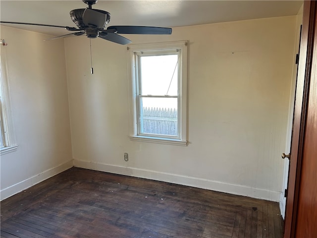 unfurnished room with ceiling fan and dark wood-type flooring