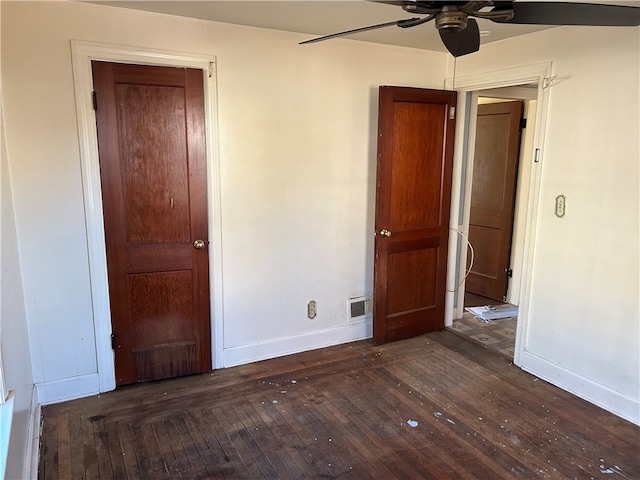 unfurnished bedroom featuring dark hardwood / wood-style floors and ceiling fan