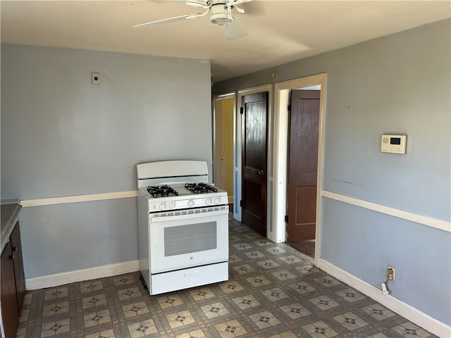 kitchen featuring white range with gas cooktop and ceiling fan