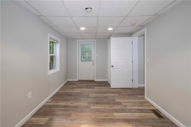 entryway with hardwood / wood-style flooring and a drop ceiling