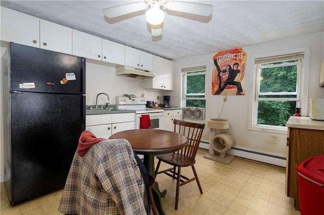 kitchen with plenty of natural light, black refrigerator, electric stove, and white cabinetry