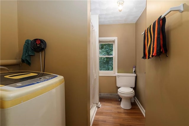 bathroom featuring hardwood / wood-style floors and toilet