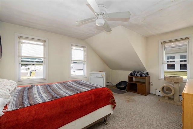 bedroom with carpet flooring, ceiling fan, a baseboard radiator, and vaulted ceiling