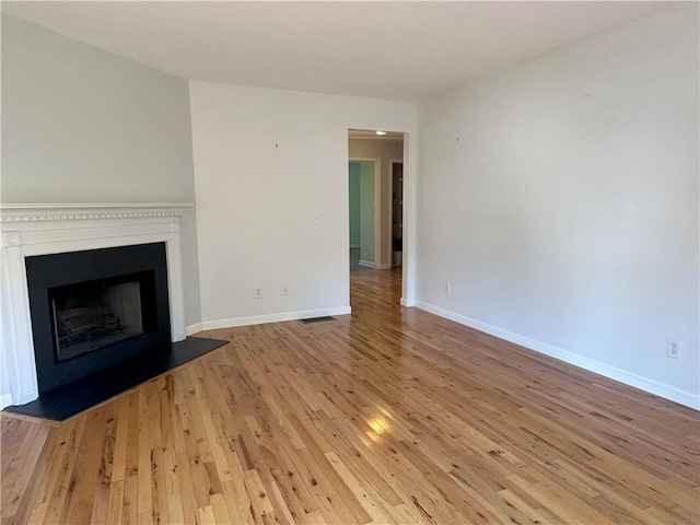 unfurnished living room with light hardwood / wood-style floors