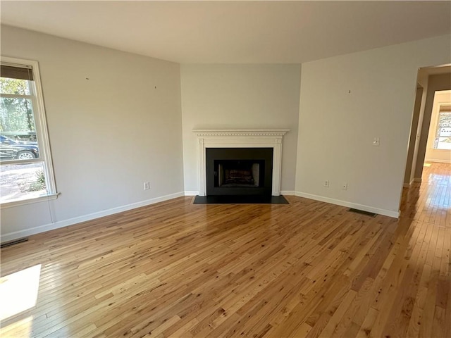 unfurnished living room with light hardwood / wood-style floors