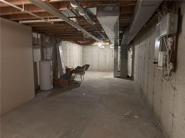 basement featuring electric water heater and heating unit