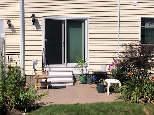 entrance to property featuring a patio area