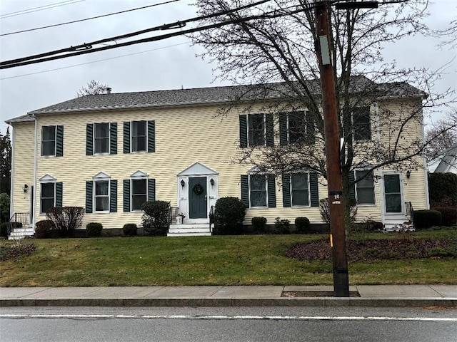 colonial-style house with a front yard