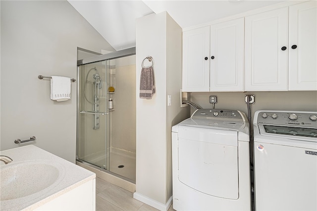 clothes washing area featuring washer and clothes dryer and light tile patterned flooring