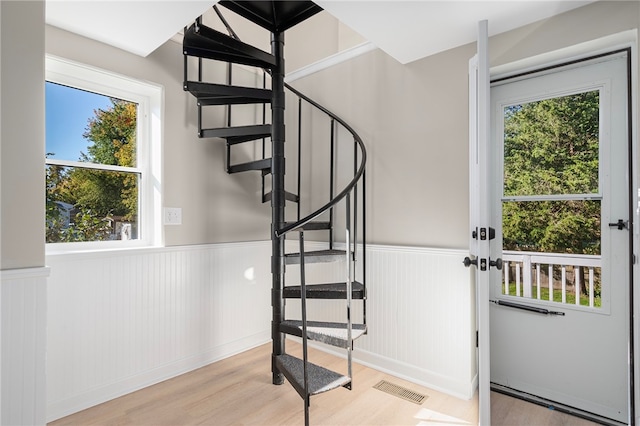 interior space featuring a wealth of natural light and hardwood / wood-style floors