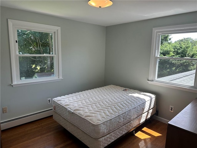 bedroom featuring a baseboard radiator and dark wood-type flooring