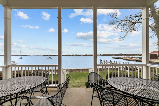 sunroom / solarium featuring a water view