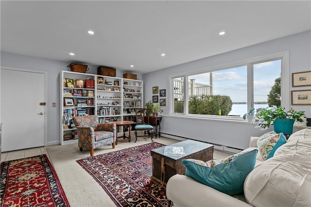 living room with baseboard heating and a water view