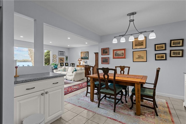 tiled dining room featuring a wall unit AC