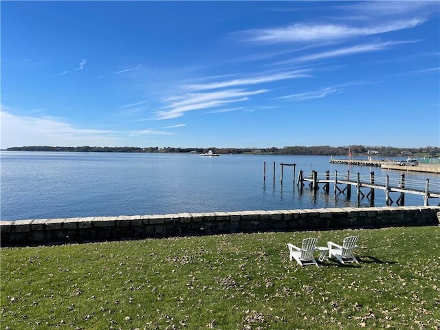 dock area with a yard and a water view