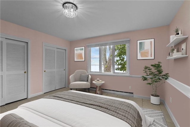 tiled bedroom featuring multiple closets, an inviting chandelier, and a baseboard radiator