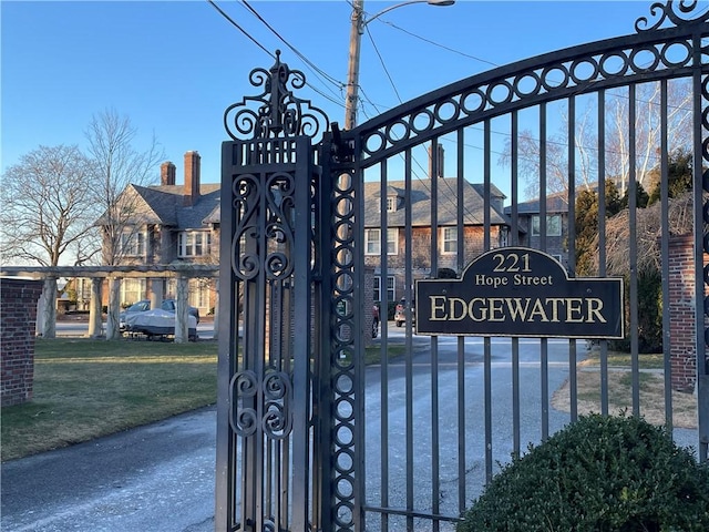 view of gate with a lawn