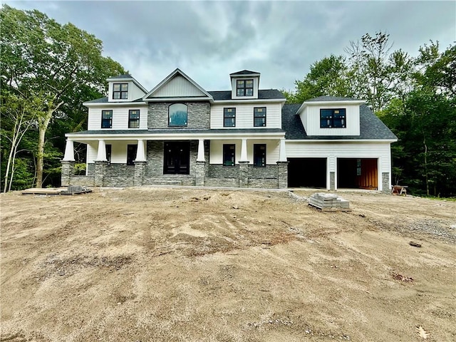 12 Beechwood Dr, Cranston, RI 02921 - view of front of house with stone siding, covered porch, and a garage
