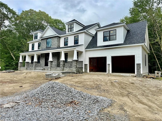 12 Beechwood Dr, Cranston, RI 02921 - view of front of house featuring a porch, driveway, a shingled roof, and stone siding