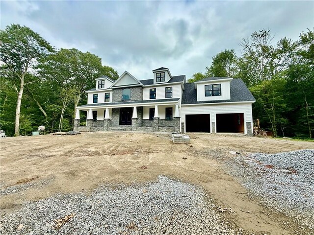 12 Beechwood Dr, Cranston, RI 02921 - view of front of home featuring a porch, a garage, stone siding, and driveway