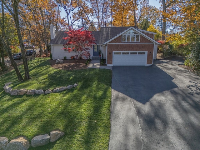 view of front of home featuring a garage and a front yard