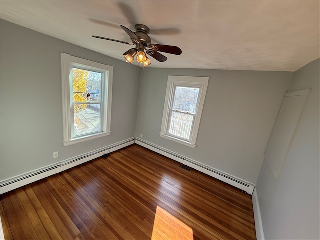 empty room featuring ceiling fan, wood-type flooring, and a baseboard radiator