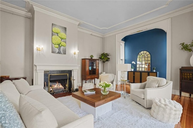 43 Old Beach Rd, Newport, RI 02840 - living room with a fireplace with flush hearth, crown molding, wood finished floors, and arched walkways