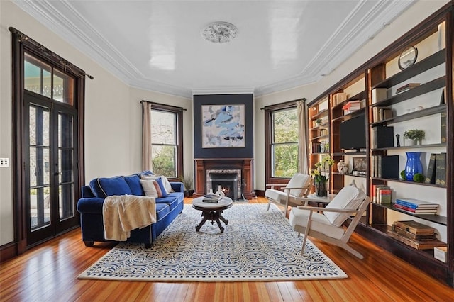 43 Old Beach Rd, Newport, RI 02840 - living area featuring wood-type flooring, crown molding, healthy amount of natural light, and a fireplace with flush hearth