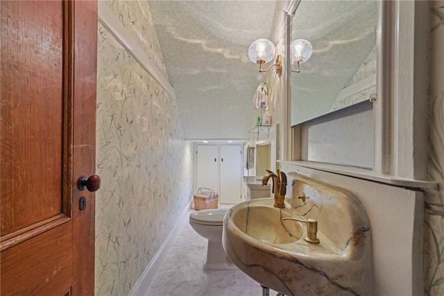 bathroom featuring toilet, a textured ceiling, and vaulted ceiling