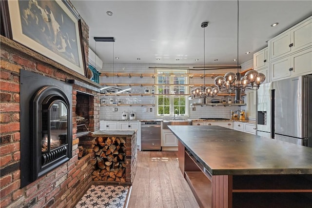 43 Old Beach Rd, Newport, RI 02840 - kitchen featuring open shelves, stainless steel appliances, a sink, pendant lighting, and decorative backsplash