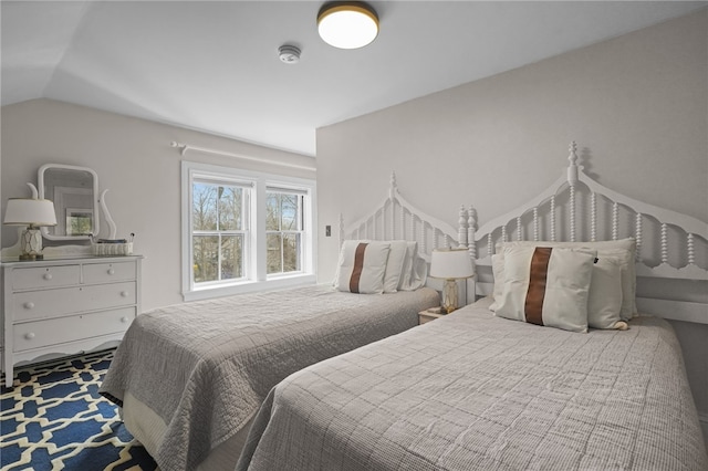 bedroom featuring carpet floors and vaulted ceiling