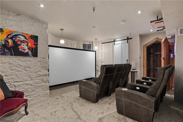 home theater featuring a barn door and light colored carpet