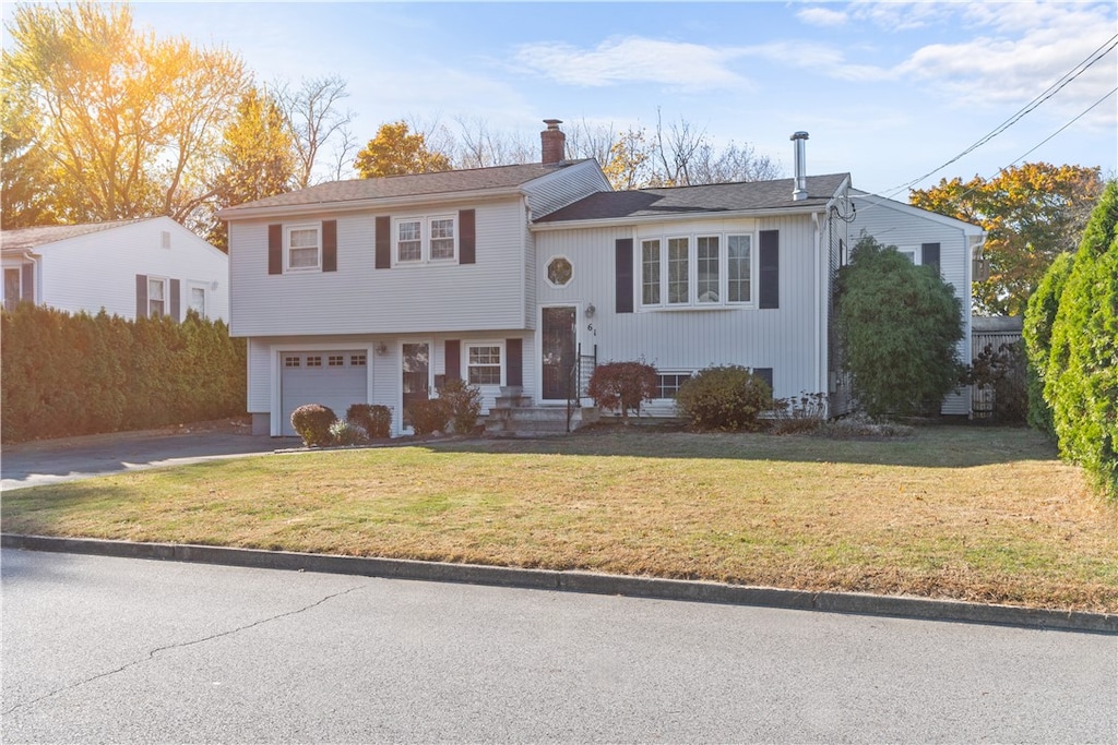 view of front of property with a garage and a front yard