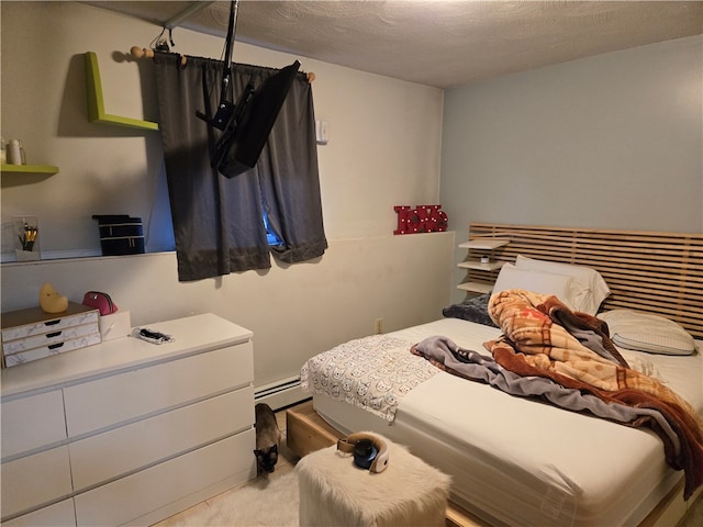 carpeted bedroom featuring a textured ceiling and a baseboard heating unit