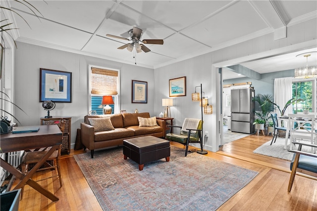 living room featuring crown molding, ceiling fan, and hardwood / wood-style flooring