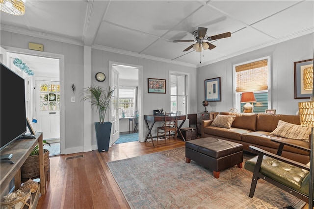 living room featuring ceiling fan, crown molding, a healthy amount of sunlight, and hardwood / wood-style flooring