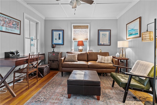 living room featuring hardwood / wood-style flooring, ceiling fan, and crown molding