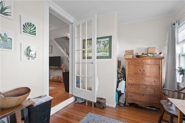 living area with dark hardwood / wood-style flooring and ornamental molding