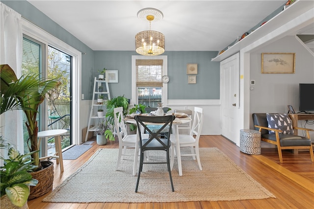 dining room with hardwood / wood-style flooring and an inviting chandelier