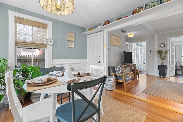 dining area with hardwood / wood-style floors and beam ceiling