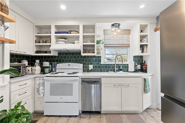 kitchen featuring white cabinets, appliances with stainless steel finishes, tasteful backsplash, and sink