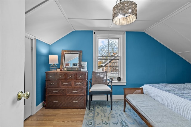 bedroom with light wood-type flooring and lofted ceiling