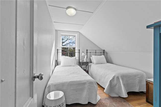 bedroom featuring lofted ceiling and hardwood / wood-style flooring