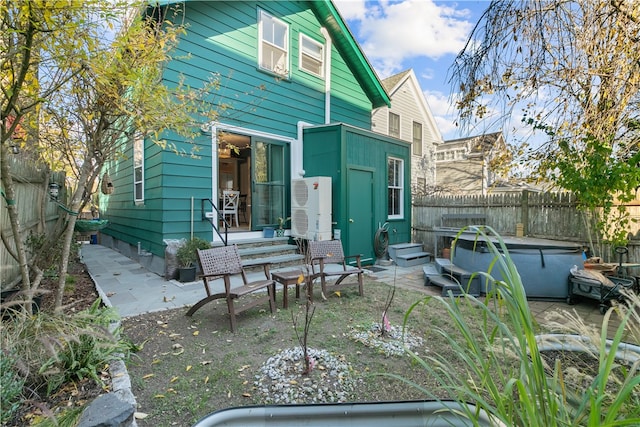 back of house featuring ac unit and a patio