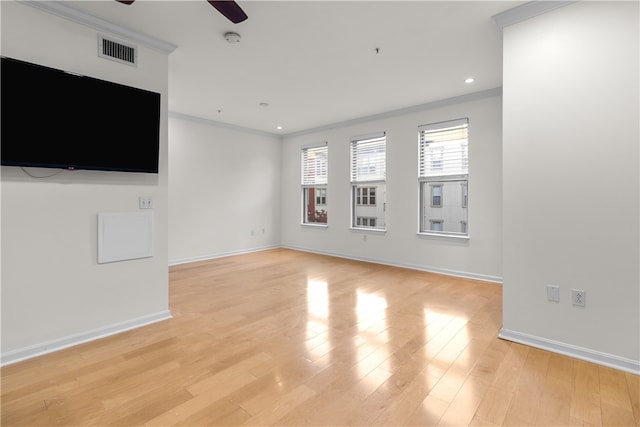 unfurnished living room featuring crown molding, ceiling fan, and light wood-type flooring