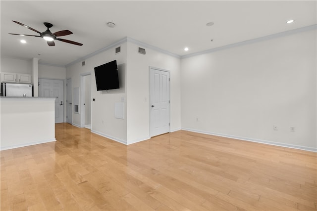 unfurnished living room with ceiling fan, ornamental molding, and light hardwood / wood-style floors