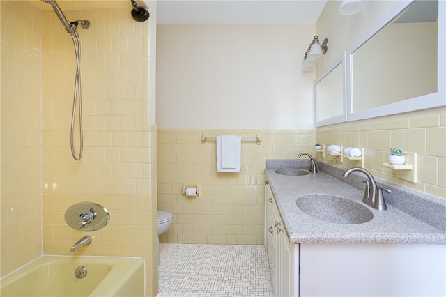 full bathroom with tile patterned floors, vanity, tile walls, and toilet