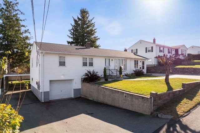 view of front of home featuring a front yard and a garage